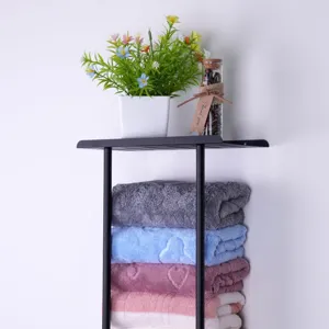 Wall-mounted metal storage rack with layered colorful towels for modern bathroom organization.