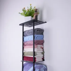 Bathroom metal wall shelf detail, space-saving towel organizer rack for home storage use.
