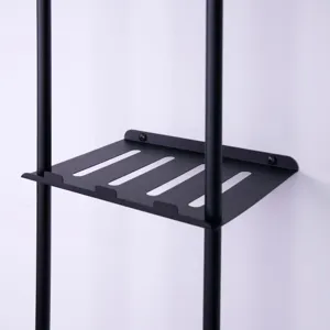 Black metal wall mounted shelf detail view, bathroom storage rack bracket close up.