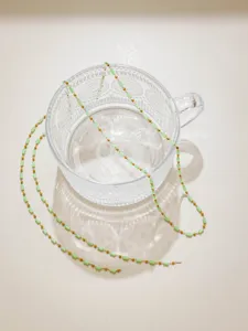 DIY green crystal tube and gold bead chain detail view for handmade jewelry making.
