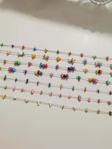 Detailed close up of colorful bohemian shell beaded chain for DIY jewelry making accessories.