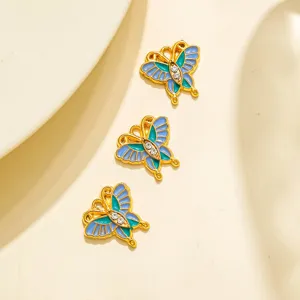 Pendentif papillon en émail acier inoxydable DIY bijoux avec strass bleus et verts brillants.
