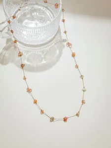 Roestvrijstalen goudkleurige ketting met roze natuurstenen voor DIY sieraden details.