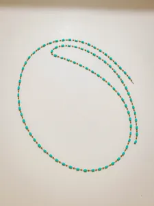 Turquoise tube and gold bead chain detail, perfect for DIY jewelry crafting and handmade necklaces.