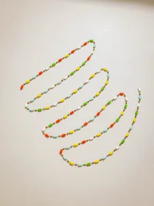 Detailed view of colorful crystal tube and gold bead handmade DIY jewelry chain materials.