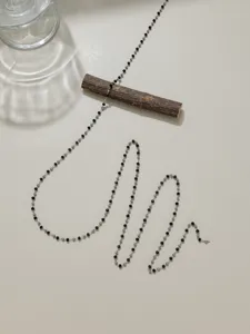 Stainless steel beaded chain detail showing black crystals and metal spacers for DIY jewelry.