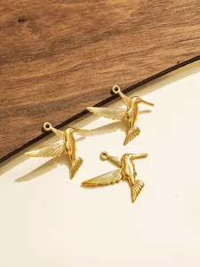 Detail view of three gold hummingbird metal charms for DIY jewelry making and accessories.