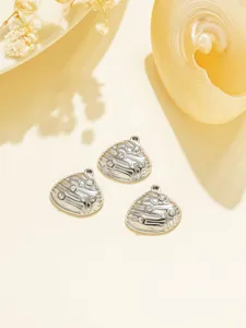 Close-up of stainless steel rhinestone shell charms, perfect for DIY jewelry making.