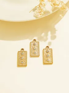 Close-up details of gold rectangular starburst rhinestone DIY jewelry pendant charms accessories.