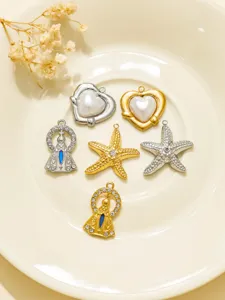Vintage stainless steel DIY jewelry pendants set featuring hearts, starfish and religious motifs.
