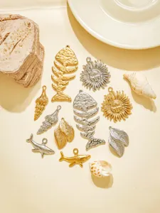 Close-up details of stainless steel island style fish bone and sun charm pendants for DIY jewelry.