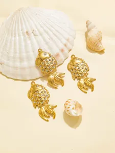 Close-up detail of golden fish pendant featuring rhinestone scales and stainless steel design.
