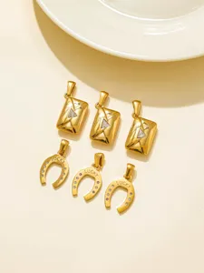Detail view of gold horseshoe and envelope charms with rhinestones, perfect for DIY crafts.