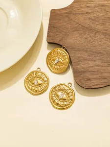 Detailed shot of retro stainless steel evil eye gold pendants, perfect for DIY jewelry making.