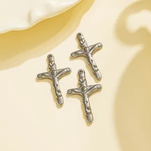 Detailed close-up shot of vintage stainless steel cross pendant for DIY jewelry making accessories.