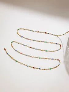 Close-up of stainless steel fine chain with colorful candy beads, perfect for DIY jewelry.