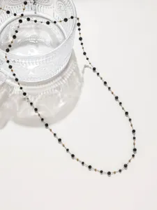 Nahaufnahme einer zarten schwarzen Kristallperlen-Kette, perfekt für DIY-Schmuckdesign.