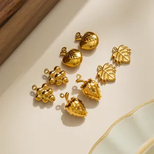 Stainless steel fruit charm details showing gold apple, strawberry, grape, and leaf pendants.