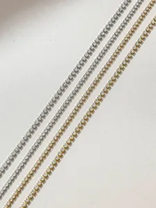 Close-up of sparkling rhinestone chains, silver and gold cup chains for DIY crafts.