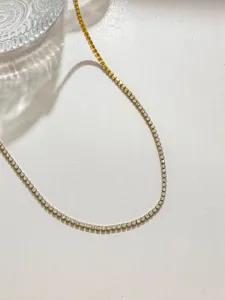 Close-up of sparkling gold-tone rhinestone cup chain, ideal for DIY jewelry and crafts.