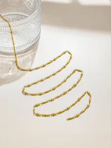 Close-up of gold stainless steel bead chain, perfect for DIY jewelry making and crafting.