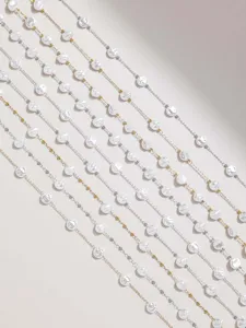 Detailed view of DIY jewelry chains featuring irregular pearls and metallic beads for crafts.