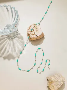 Details of DIY jewelry chain with turquoise water drop beads and pearls for handmade crafts.