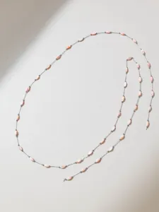 Detail shot of French gentle style pink shell seed bead chain, DIY jewelry accessory.