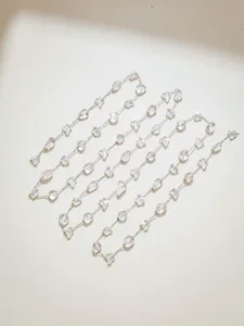 Detailed view of DIY crystal stone and butterfly chain materials for handmade necklaces and crafts.