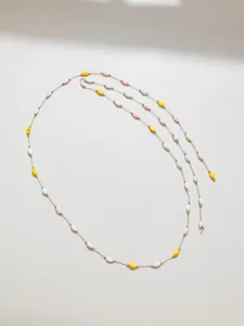 Macaron shell bead chain detail view, delicate gold metallic link for DIY jewelry crafting.