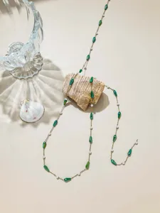 Detailed view of 1-meter DIY jewelry chain with green teardrop beads and white pearls.