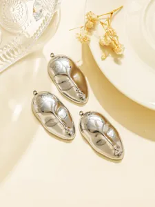 Stainless steel abstract face pendant detail view, perfect for DIY jewelry making and keychains.