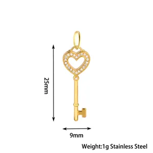 Detail shot of the gold stainless steel heart key pendant, paved with stones, 25x9mm.