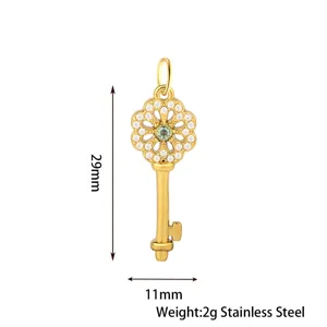 Stainless steel key pendant detail view, golden finish with sparkly cubic zirconia crystals.