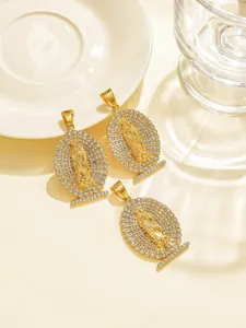 Detailed close-up of gold rhinestone-inlaid portrait pendants showcasing exquisite craft and shine.