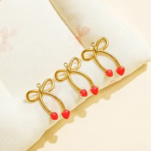 Gold bow and red heart metal pendant for DIY custom necklaces and fashion hat accessories.