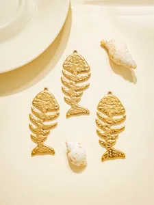 Detail shot of golden fish bone pendant accessory, perfect for custom DIY island jewelry crafting.