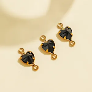 Closeup of 3 black heart crystal double-loop stainless steel charms for DIY jewelry making.