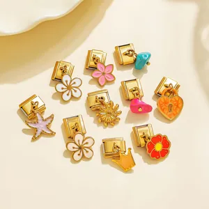 Detail view of various stainless steel Italian charm links and pendants for DIY bracelets.