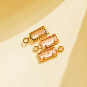 Detailed shot of rectangular pink crystal charms with gold-plated bezels for DIY.