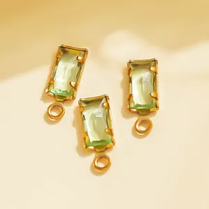 Closeup of green crystal pendant with gold bezel, perfect for DIY jewelry and crafts making.