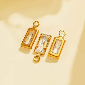Close-up detail of vintage style geometric stainless steel bezel crystal pendant charms for DIY.
