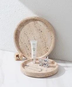 Natural travertine round tray detail shot, elegant stone home decor and display organizer.