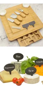 Bamboo cheese board set with knives and slate markers for serving cheese and charcuterie detail.