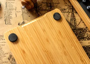 Close-up detail of rectangular bamboo wooden tray with black feet on vintage map background.