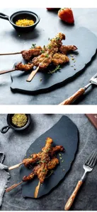Close-up detail of the black leaf-shaped slate plate showcasing natural rock texture and food presentation.