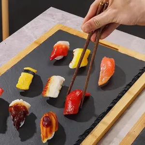 Rectangular black slate sushi plate with bamboo wooden tray for home restaurant food display.