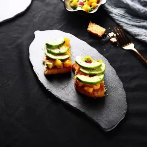 Natural slate serving plate leaf shaped black stone dinner plate for steak and food presentation.