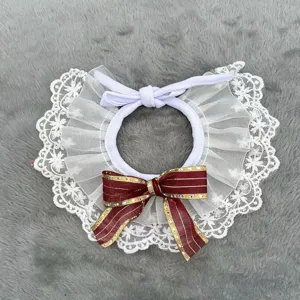 Detailed view of pet lace collar with white ruffles and elegant burgundy gold bow decoration.