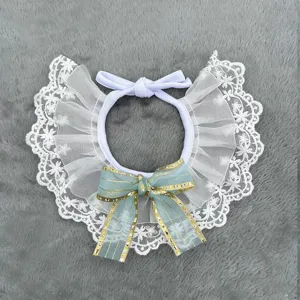 Detailed view of white lace pet collar with blue gold bow, cute cat dog bib accessory.